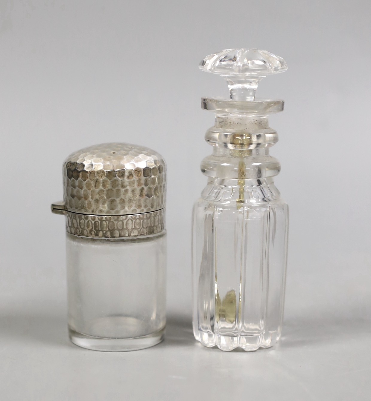 A George IV silver mounted cut glass cayenne pepper jar, John, Henry & Charles Lias, London, 1823, 11.6cm, together with a late Victorian silver mounted glass salt's bottle, JB, London, 1891.